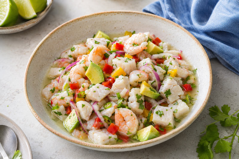 Fresh fish and shrimp ceviche with lime, red onion, cilantro, and avocado