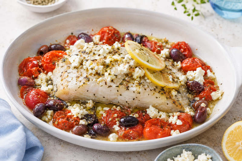 Greek-style baked Atlantic cod with tomatoes, olives, feta, lemon, and oregano