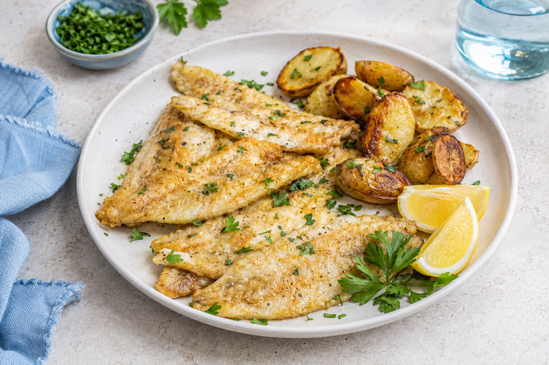 Pan-fried yellow perch fillets with lemon, herbs, and crispy potatoes