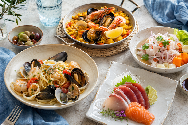International seafood dishes including paella, ceviche, sushi, and seafood pasta