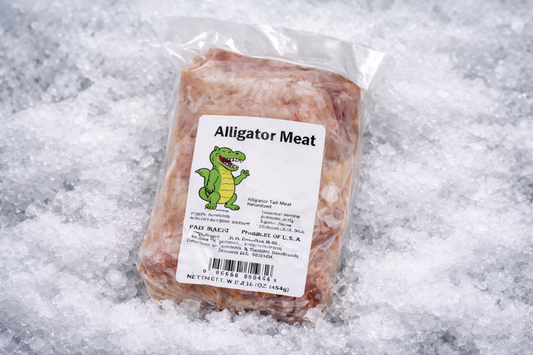 Packaged alligator meat with a label on a snowy background