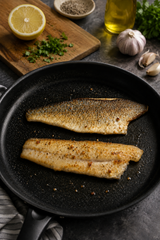 Seared fish fillets with herbs and lemon